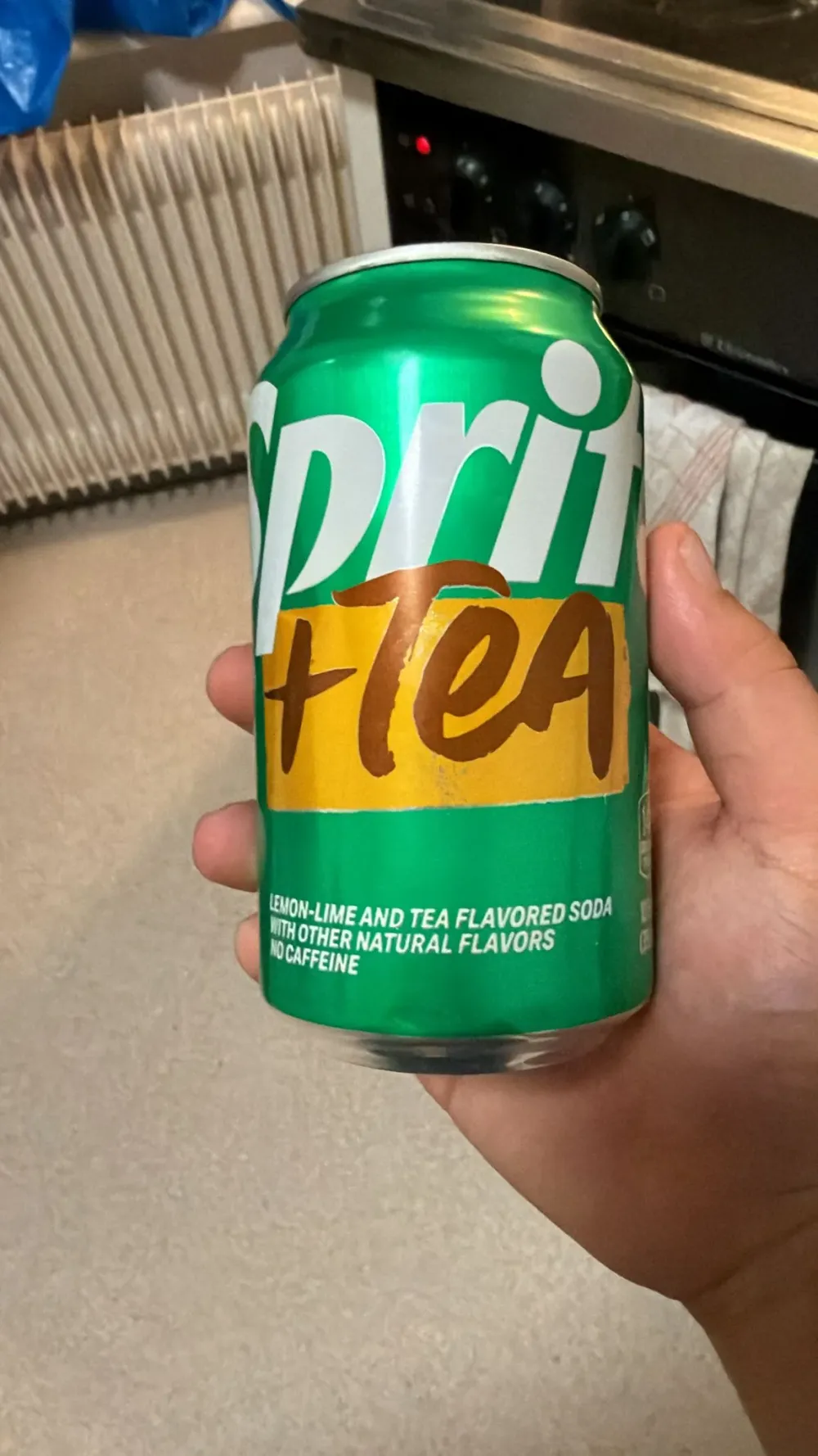 a can of Sprite + Tea held up